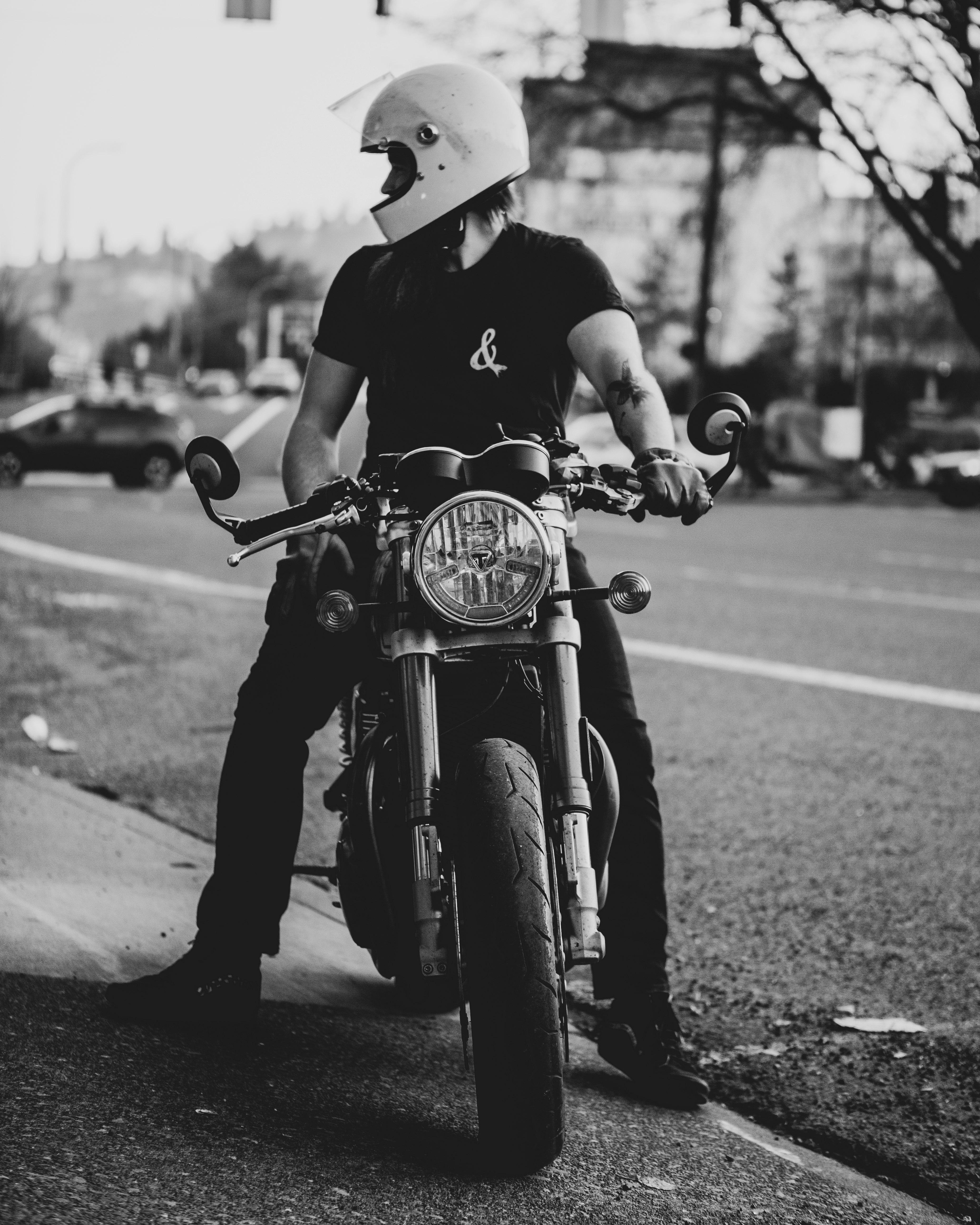 grayscale photo of man riding motorcycle